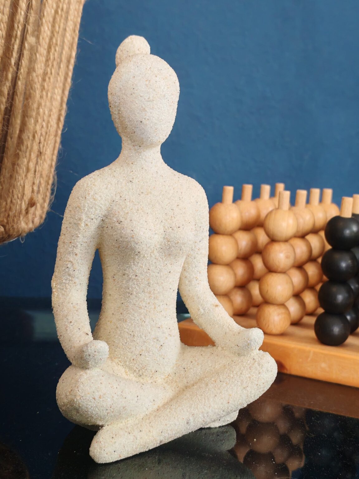 Weiße Meditationsfigur vor einer tiefblauen Wand in der Villa·51